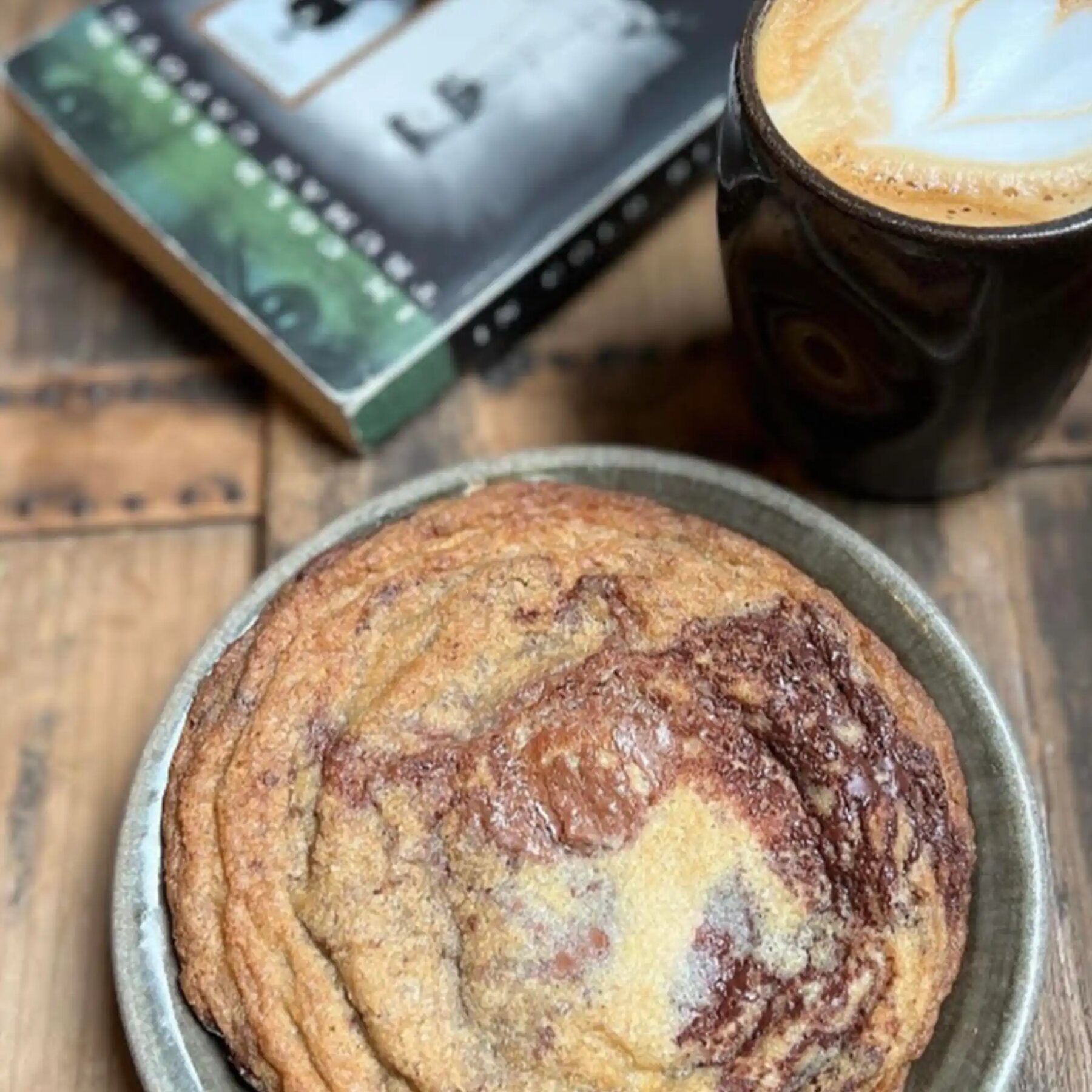 A latte with rosetta art in a handmade mug at Elevenses